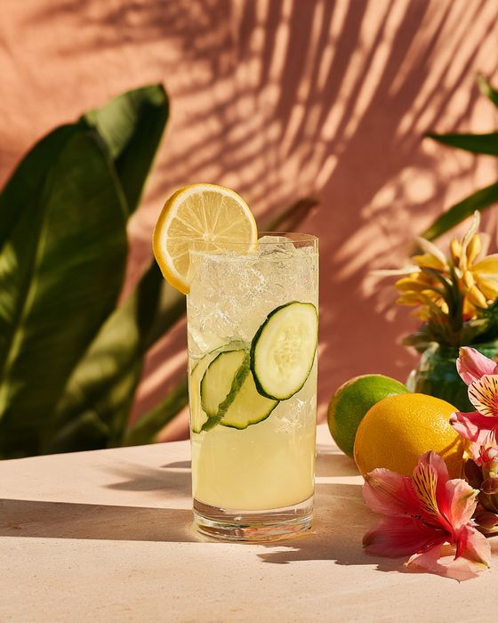 Lychee Bliss Lemonade cocktail: highball glass, garnished with cucumber slice